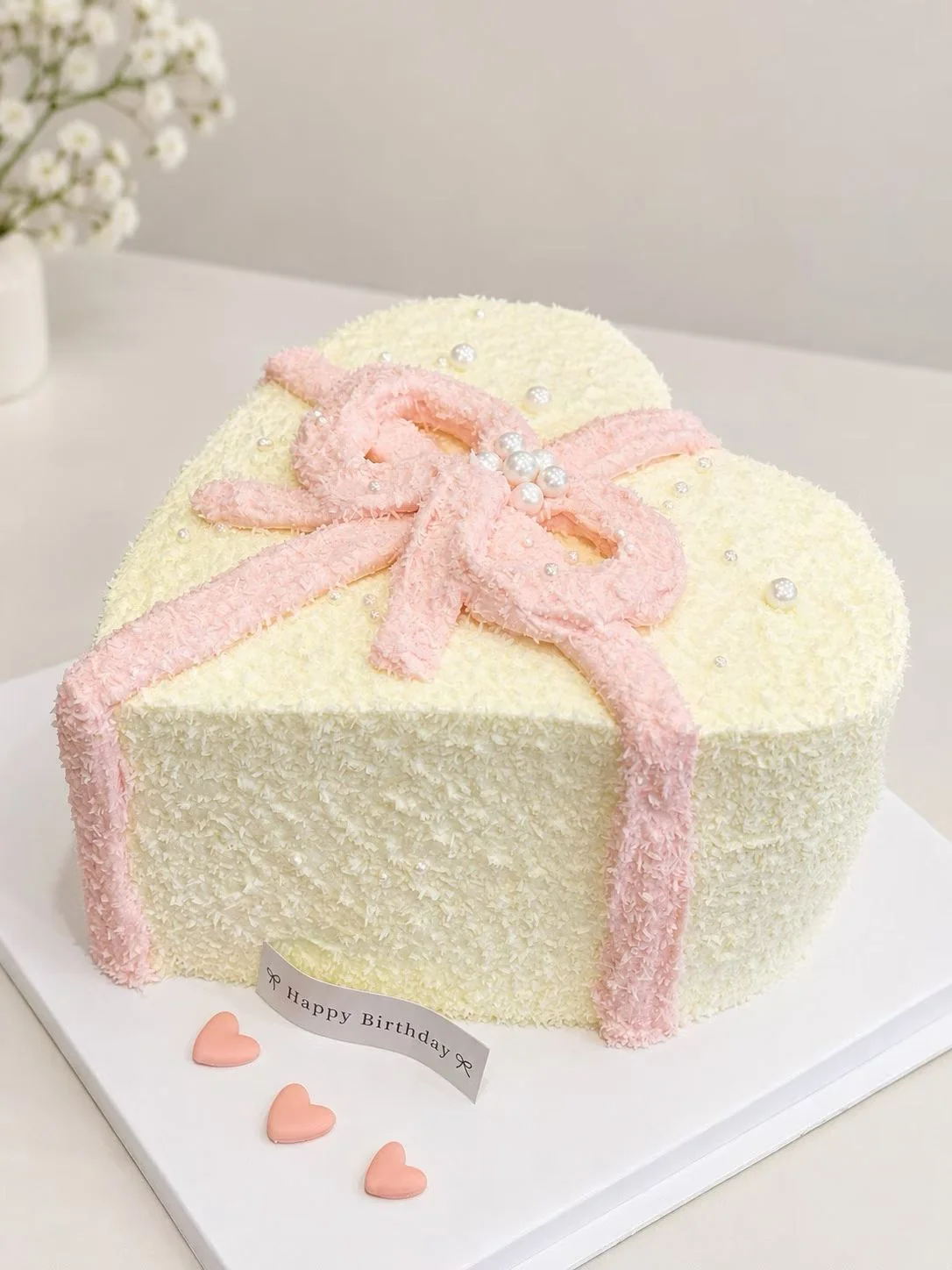 Beautiful handmade pink-ribbon celebration cake by Kanlly Bakehouse